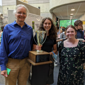 BTI REU intern Iselle Barrios holds The Colonel’s Cup Challenge trophy, awarded for winning the Best Presentation at the George and Helen Kohut Symposium