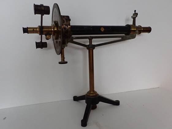 A vintage scientific microscope with brass components, mounted on a tripod stand, used for detailed biological research and microscopic analysis at Boyce Thompson Institute.