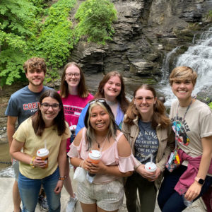 Interns standing in front of a waterfall in Ithaca