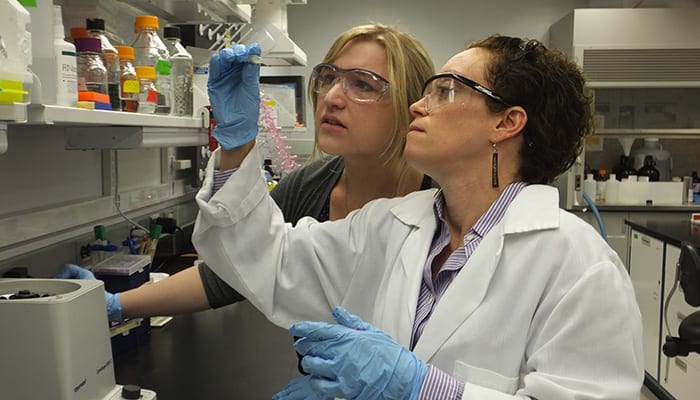 Michelle Cilia works with graduate student Annie Kruse in the lab.