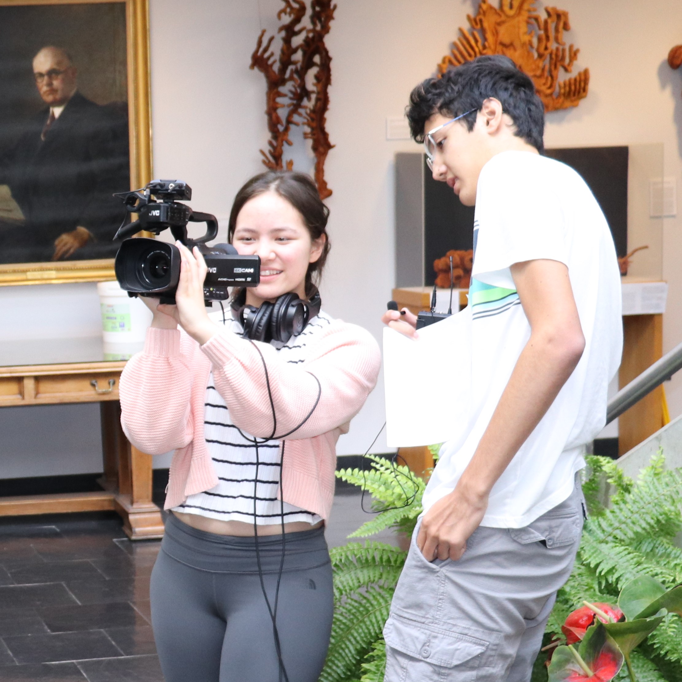 Evan James and Valerie Wansink operating a camera
