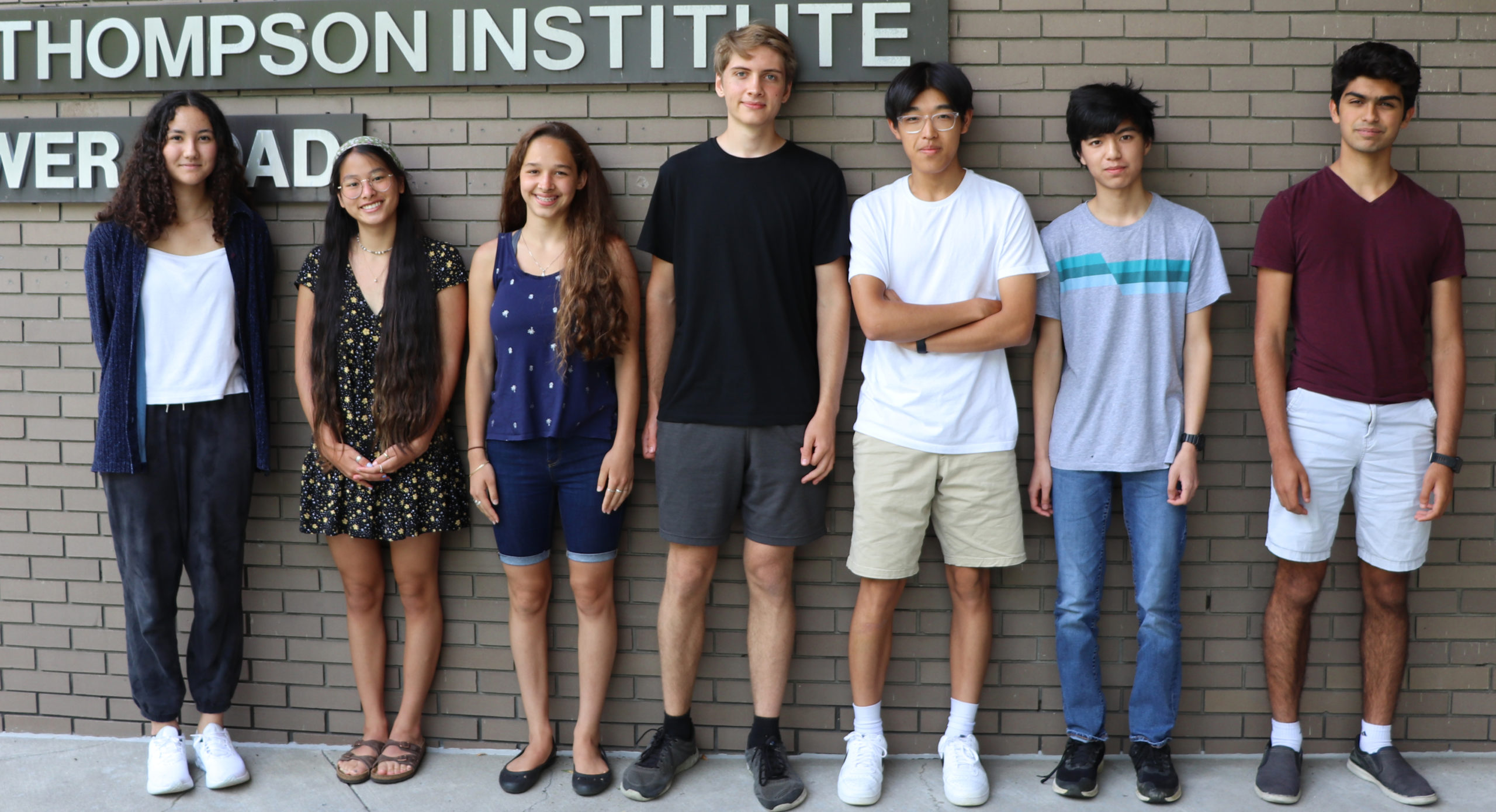 A group photo of 7 high school interns during orientation outside in front of BTI.