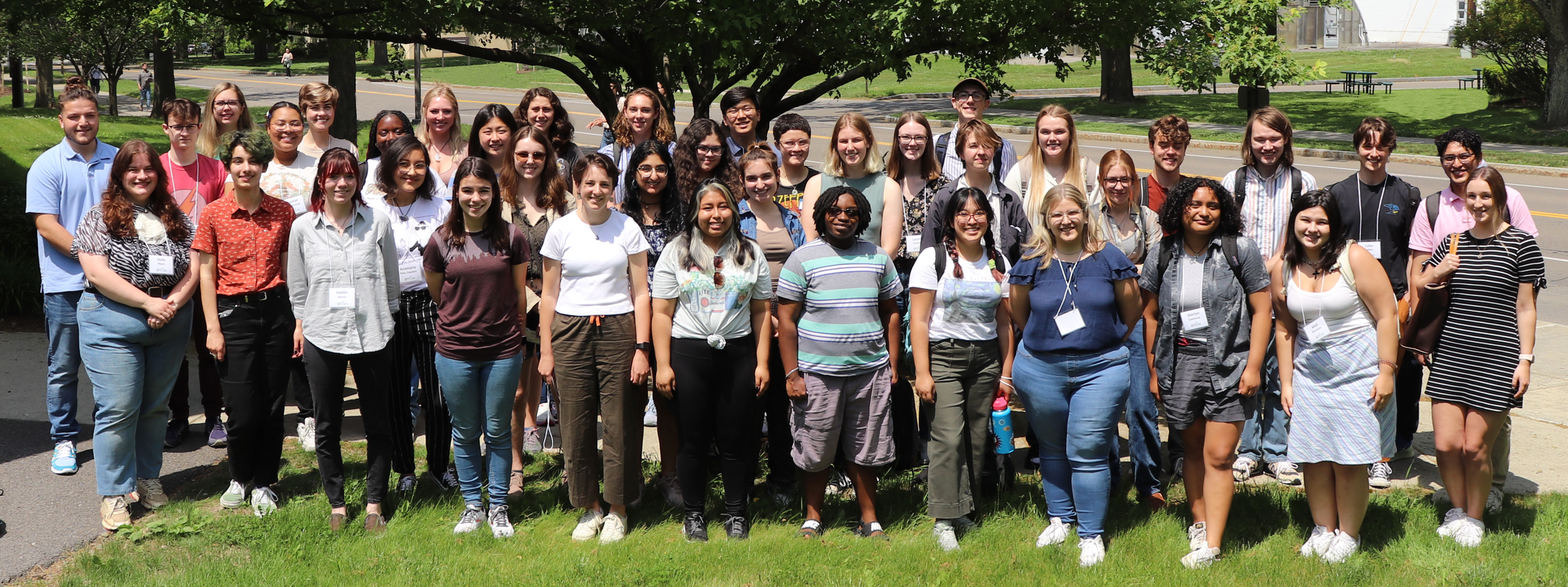 A group photo of 41 undergraduate interns during orientation outside of BTI, with a tree in the background.