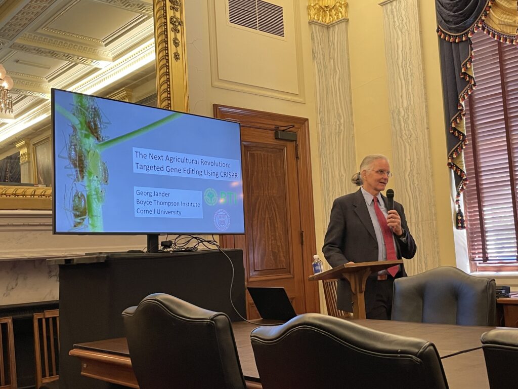 Georg Jander addressing an audience in the offices of the U.S. Senate Committee on Agriculture, Nutrition, and Forestry