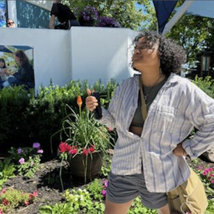 Sherlyn Contreras stands outside plants 