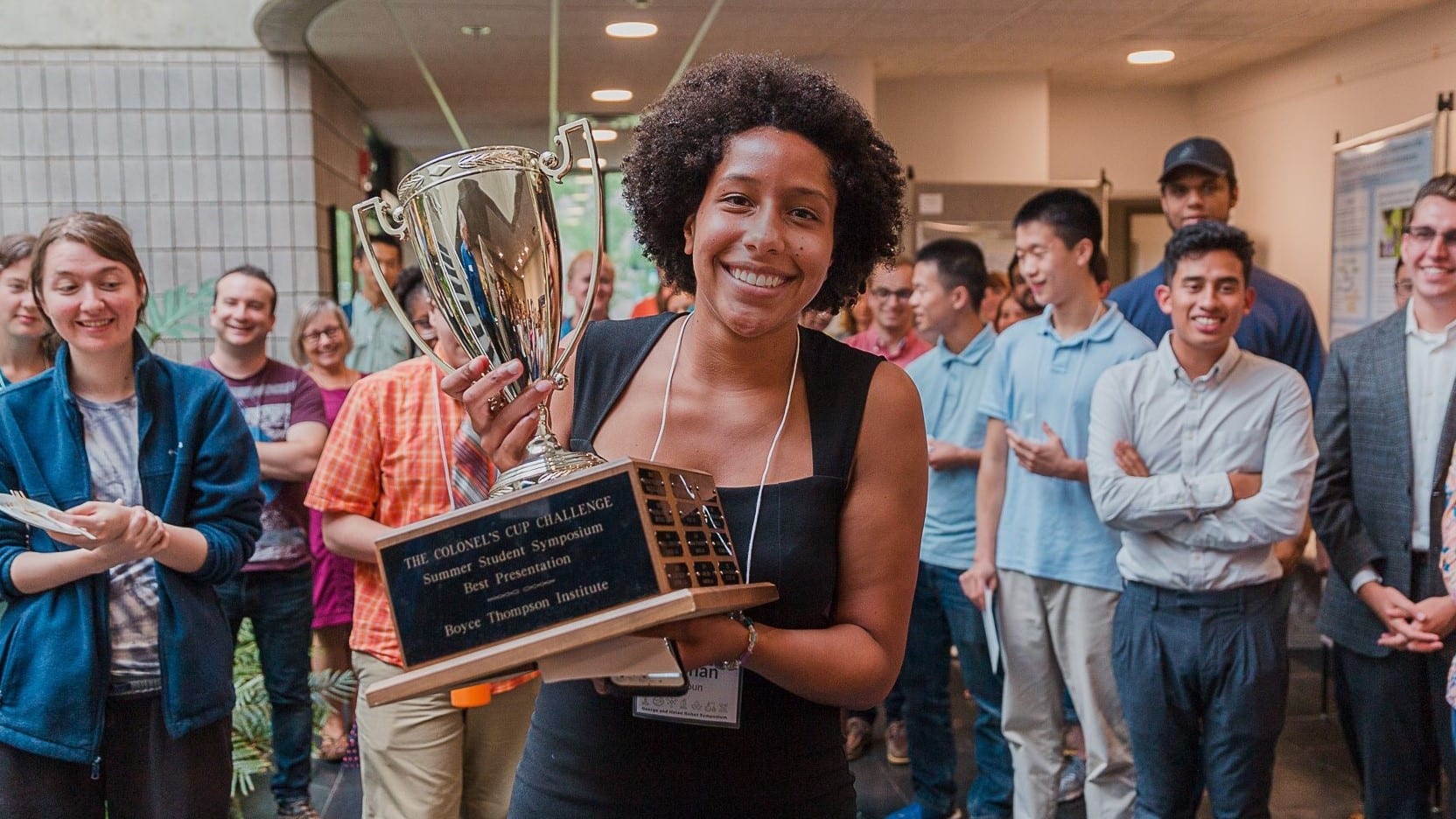 BTI intern Siobhan Calhoun holds The Colonel’s Cup Challenge trophy, awarded for winning the Best Presentation at the George and Helen Kohut Symposium on August 8, 2019. 